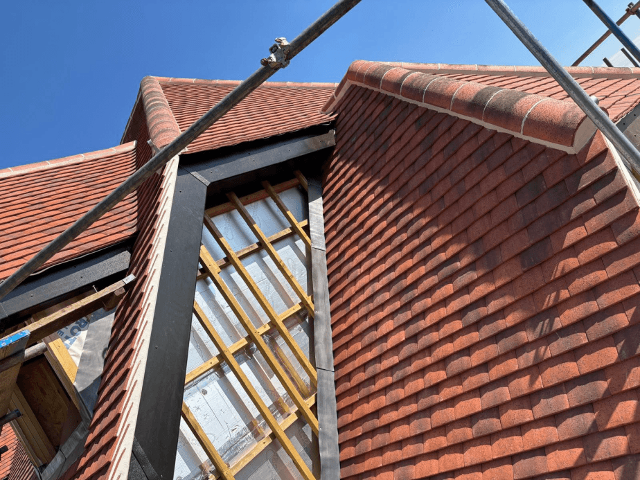 Clay roof tile installation with scaffolding
