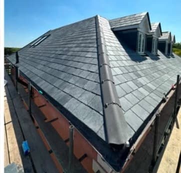 Slate roof installation close-up with dormers