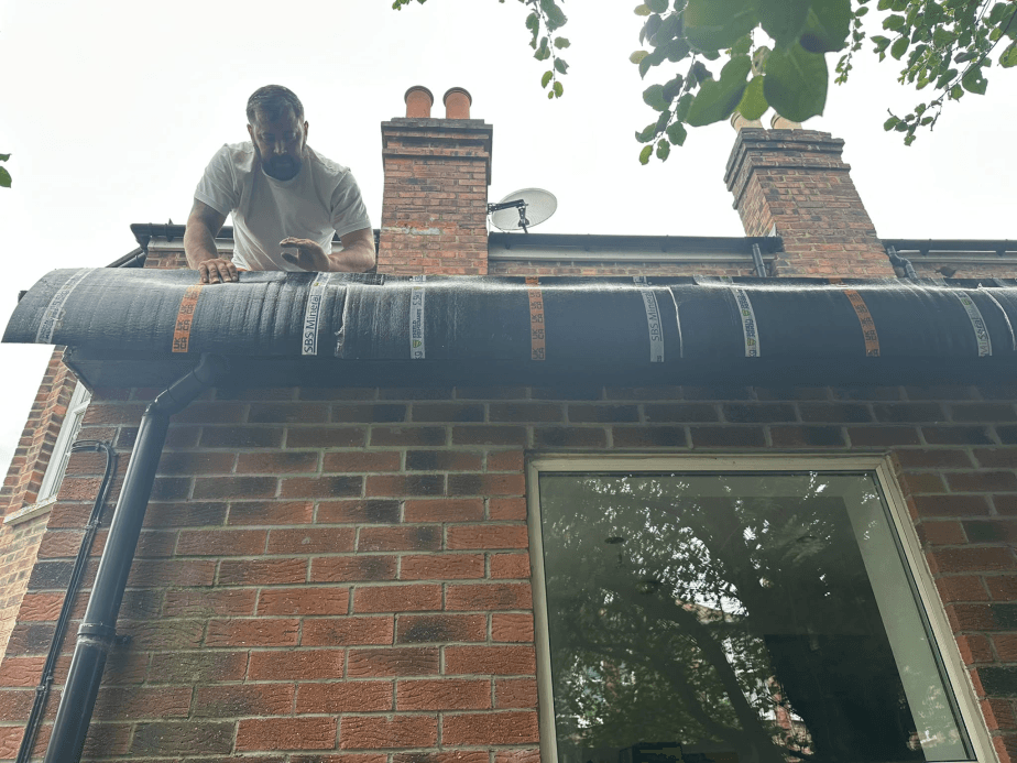Flat roof felt installation on brick terrace