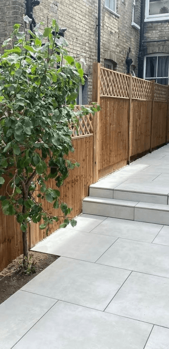 Timber fence with trellis top and paved garden